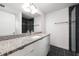 Modern bathroom featuring a granite countertop, sleek vanity, and tiled shower at 2840 S Shade Ave, Sarasota, FL 34239
