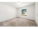 Bright bedroom with neutral carpet, a large window, and white trim at 2840 S Shade Ave, Sarasota, FL 34239