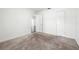 A neutral bedroom with carpet, white walls and trim, and a glimpse into another room at 2840 S Shade Ave, Sarasota, FL 34239