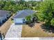 Charming single-story home featuring a brick driveway, well-maintained lawn, and mature trees at 2840 S Shade Ave, Sarasota, FL 34239