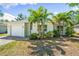 Charming single-story home featuring a well-maintained lawn, palm trees, and a brick driveway leading to an attached garage at 2840 S Shade Ave, Sarasota, FL 34239