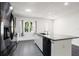 Modern kitchen boasts stainless steel appliances, granite countertops, sleek cabinetry, and an island with a sink at 2840 S Shade Ave, Sarasota, FL 34239