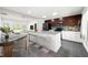 Modern kitchen with granite countertops, stainless steel appliances, and a breakfast bar overlooking the living area at 2840 S Shade Ave, Sarasota, FL 34239