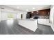 Modern kitchen boasts stainless steel appliances, granite countertops, sleek cabinetry, and an open layout leading to living area at 2840 S Shade Ave, Sarasota, FL 34239