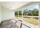The screened-in patio features stylish brick flooring and views of the lush backyard at 2840 S Shade Ave, Sarasota, FL 34239