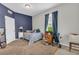 Comfortable bedroom with blue accent wall, soft carpet, and natural light creating a cozy, relaxing atmosphere at 2918 130Th E Ave, Parrish, FL 34219