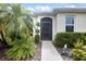 Inviting front entrance with tropical landscaping and decorative rock features at 2918 130Th E Ave, Parrish, FL 34219