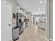 Bright, open kitchen featuring white cabinets, stainless steel appliances, and tile flooring at 2918 130Th E Ave, Parrish, FL 34219