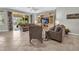 Spacious living room with tile floors, ceiling fan, and entertainment center at 2918 130Th E Ave, Parrish, FL 34219