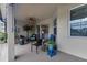 Covered patio area featuring seating, decor and access to the home at 2918 130Th E Ave, Parrish, FL 34219