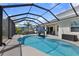 Screened-in pool area with lounge chairs and outdoor dining at 2918 130Th E Ave, Parrish, FL 34219