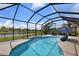 Beautiful screened-in pool area with clear blue water and view of the lake at 2918 130Th E Ave, Parrish, FL 34219
