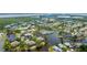 Aerial view of a residential community featuring waterfront properties, lush landscaping, and a central pool area at 304 108Th W St, Bradenton, FL 34209