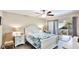 Bright bedroom features a ceiling fan, tile floors, and a private balcony overlooking the water at 304 108Th W St, Bradenton, FL 34209