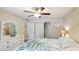A bedroom features white furniture, a ceiling fan, and closet doors at 304 108Th W St, Bradenton, FL 34209