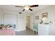 Neutral-toned bedroom features tile floors, ceiling fan and closet at 304 108Th W St, Bradenton, FL 34209
