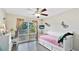 Bright bedroom features tile floors, ceiling fan, a large window, and unique lizard decorations at 304 108Th W St, Bradenton, FL 34209