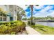 Beautiful exterior view of condo with lush landscaping and serene lakeside setting at 304 108Th W St, Bradenton, FL 34209