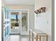 Welcoming foyer features a stylish coat rack and bench, with a glimpse of the water view at 304 108Th W St, Bradenton, FL 34209