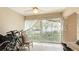 The outdoor patio with a ceiling fan features chairs and bicycles at 304 108Th W St, Bradenton, FL 34209