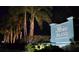 Elegant Perico Island sign with palm trees creating a welcoming entrance at night at 304 108Th W St, Bradenton, FL 34209