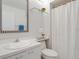 Clean bathroom featuring white fixtures, a mirrored vanity, and essential amenities, providing a functional space at 3201 Casey Key Rd, Nokomis, FL 34275