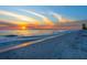 Beautiful beach at sunset with colorful skies, calm water, and footprints in the sand at 3201 Casey Key Rd, Nokomis, FL 34275