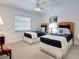 Cozy bedroom with two twin beds, nautical accents, and bright natural light, ideal for or guests at 3201 Casey Key Rd, Nokomis, FL 34275