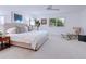 Bright bedroom features neutral tones, large windows, and contemporary decor, creating a serene and inviting space at 3201 Casey Key Rd, Nokomis, FL 34275