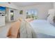 Well-lit bedroom with plantation shutters and a view to the outside balcony at 3201 Casey Key Rd, Nokomis, FL 34275