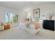 Bright bedroom with plantation shutters featuring a glimpse of the ocean view at 3201 Casey Key Rd, Nokomis, FL 34275