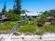 Exterior of beach house with lush greenery and private beach access at 3201 Casey Key Rd, Nokomis, FL 34275