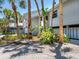 Inviting exterior with vibrant tropical plants, mature palms, and a serene ambiance, adding to the home's allure at 3201 Casey Key Rd, Nokomis, FL 34275