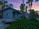 Inviting two-story home with a red door, garage, and beautifully landscaped yard at 3201 Casey Key Rd, Nokomis, FL 34275