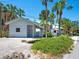 Charming single Gathering home with lush landscaping, palm trees and gravel driveway at 3201 Casey Key Rd, Nokomis, FL 34275