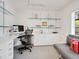 Bright home office featuring custom built-ins and comfortable seating area at 3201 Casey Key Rd, Nokomis, FL 34275