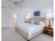 Comfortable main bedroom showcasing a plush bed, soft colors, and natural light, perfect for relaxation at 3201 Casey Key Rd, Nokomis, FL 34275