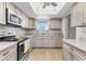 Bright kitchen featuring stainless steel appliances, natural light, and light wood-look flooring at 3204 Lake Bayshore Dr # 407, Bradenton, FL 34205