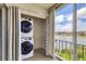 Enclosed lanai featuring stacked washer and dryer, as well as views of the lake at 3204 Lake Bayshore Dr # 407, Bradenton, FL 34205