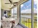 Enclosed lanai with table and chairs, ceiling fan, and views of the lake at 3204 Lake Bayshore Dr # 407, Bradenton, FL 34205