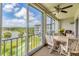 Enclosed lanai with seating, ceiling fan, and views of the lake at 3204 Lake Bayshore Dr # 407, Bradenton, FL 34205