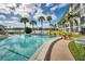 Inviting community pool area with chairs and a serene lake view at 3204 Lake Bayshore Dr # 407, Bradenton, FL 34205