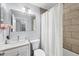 Bathroom featuring stylish vanity, tiled shower with curtain, neutral walls, and modern fixtures at 3251 Beneva Rd # 104, Sarasota, FL 34232