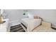 Bright bedroom featuring a queen-size bed, neutral walls, tile floors, a window, and ample natural light at 3251 Beneva Rd # 104, Sarasota, FL 34232