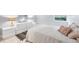 Well-lit bedroom featuring a queen-size bed, neutral walls, tile floors, a window, and modern lamps at 3251 Beneva Rd # 104, Sarasota, FL 34232