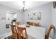 Neutral dining room features a wood table and chairs, a decorative chandelier, and access to the cozy kitchen at 3251 Beneva Rd # 104, Sarasota, FL 34232