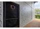 Condo entrance featuring a black door with a decorative wreath and textured stucco wall at 3251 Beneva Rd # 104, Sarasota, FL 34232