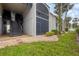 Condo exterior with stairs, gray paint, and mature landscaping, providing a welcoming and well-maintained appearance at 3251 Beneva Rd # 104, Sarasota, FL 34232