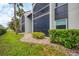 Well-maintained condo with neutral colors, complemented by lush greenery, showcasing its inviting exterior and landscaping at 3251 Beneva Rd # 104, Sarasota, FL 34232