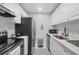 Modern kitchen with white cabinets, stainless steel appliances, and updated countertops at 3251 Beneva Rd # 104, Sarasota, FL 34232